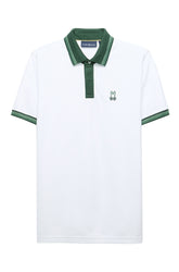 Men's white short sleeve polo with chest bunny logo, cuff trim, placket and green collar, product view by Psycho Bunny