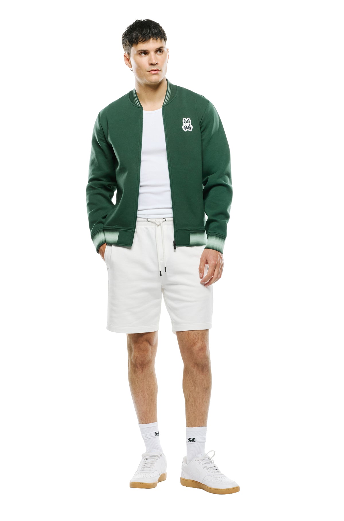 Psycho Bunny men's full front model view of dark green zip bomber jacket with light green striped rib hem and cuffs
