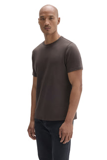 Men's angled model view of a dark taupe brown short sleeve crewneck T-Shirt with plain front, side view by Robert Barakett