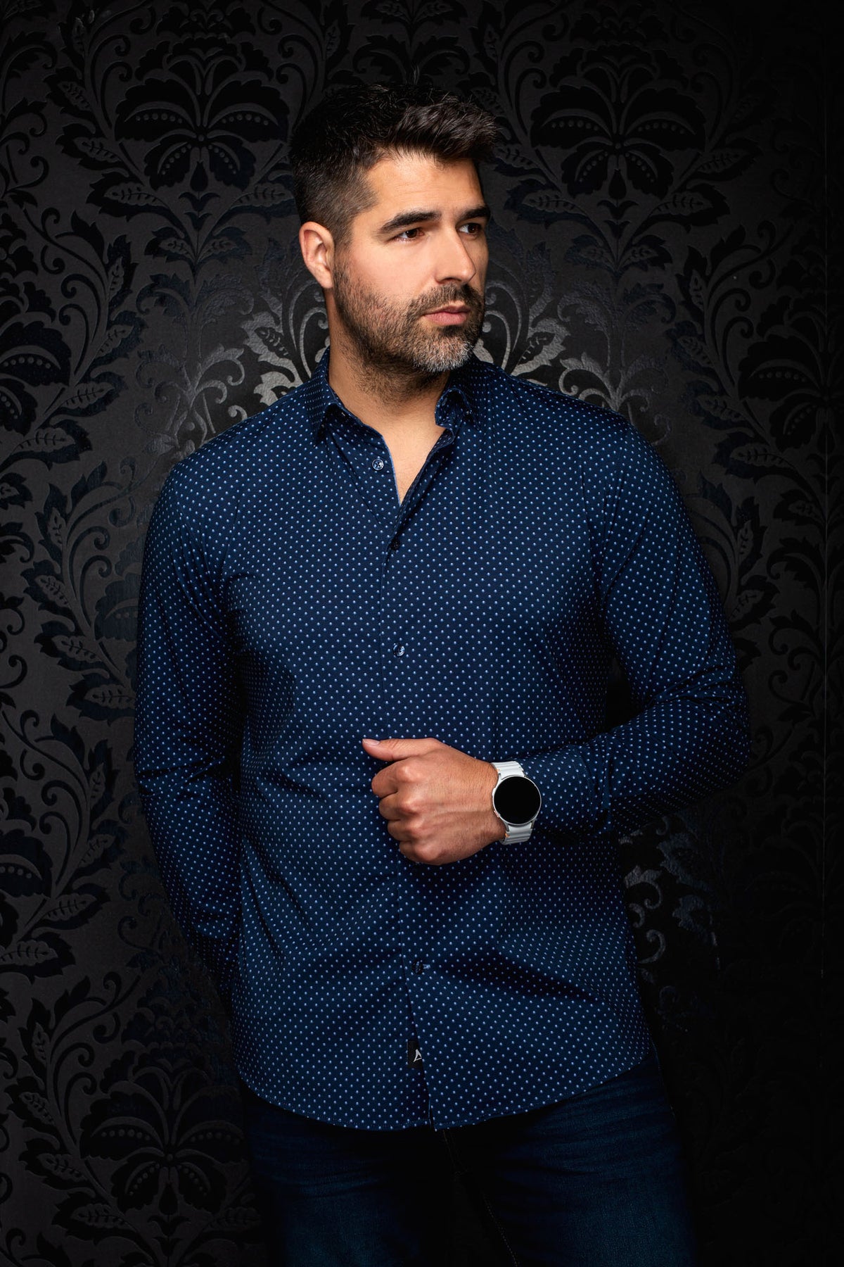 Men's navy long sleeve button-up shirt with small light blue dot print, front model view with open collar by Au Noir