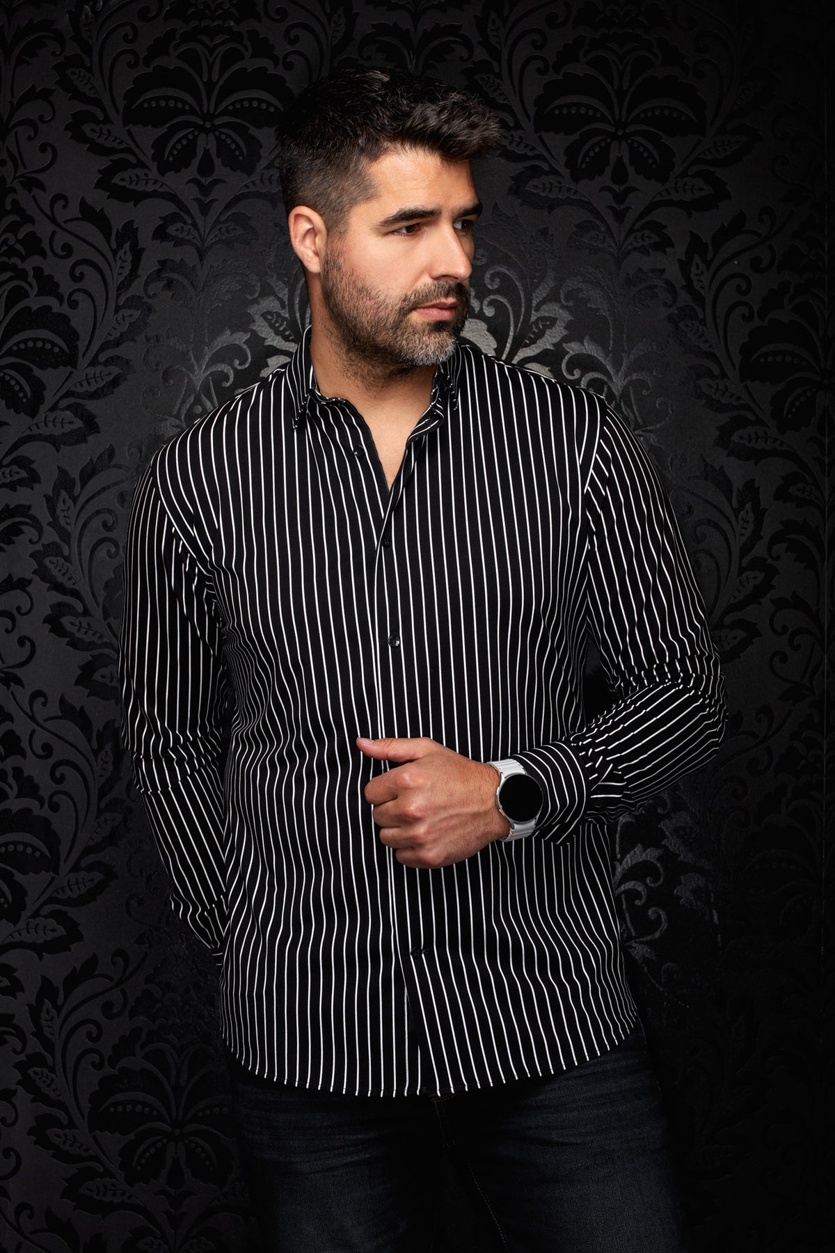 Men's black shirt with thin white vertical stripes, front model view with open collar and buttons by Au Noir