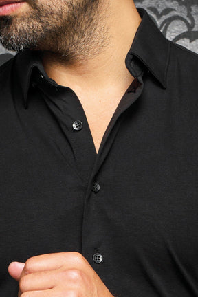 Close-up of men's black shirt showing classic collar, button placket, and black buttons by Au Noir