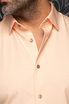 Au Noir men's collar detail of a peach button-up shirt with smooth fabric and glossy brown buttons