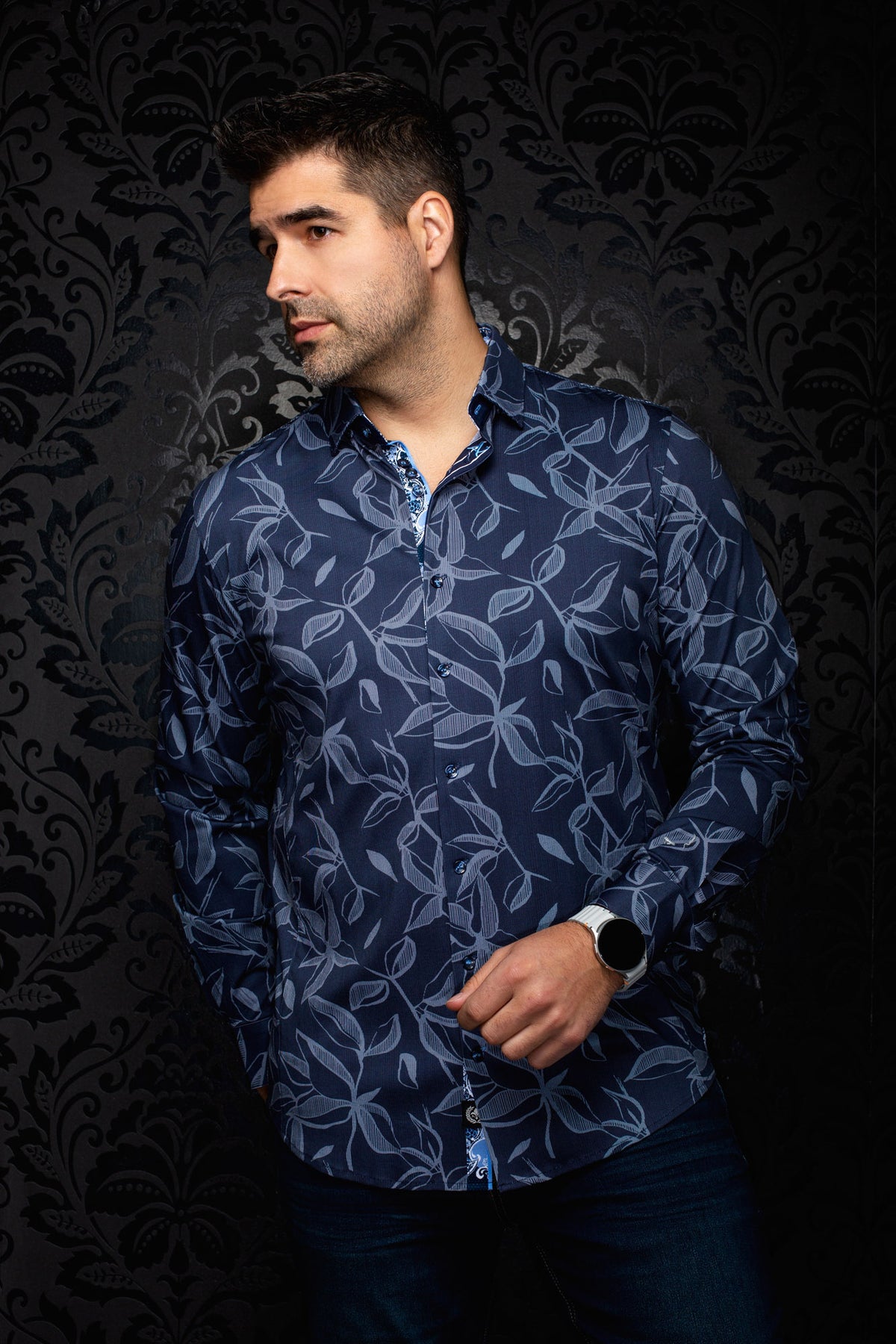 Men's angled model view of navy button-up shirt with light blue leaf print and contrast placket trim, side view by Au Noir