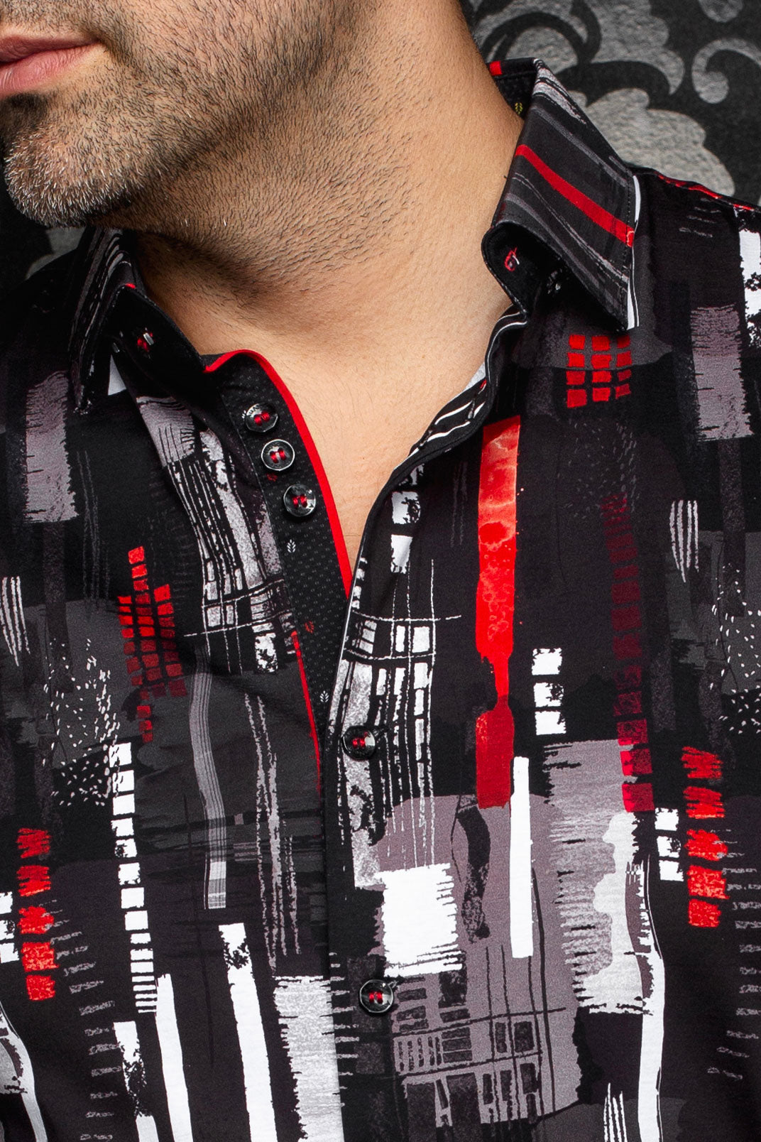 Au Noir men's black printed button-up shirt collar with red piping and striped inner collar detail, close-up