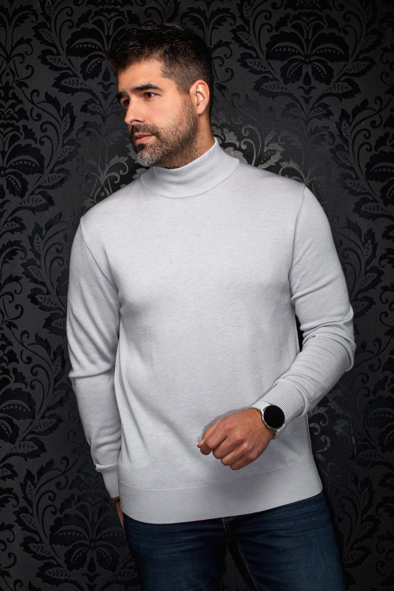 Men's light gray turtleneck knit merino sweater shown from the front with ribbed cuffs and hem by Au Noir