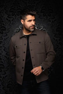 Front model view of men's brown overshirt with shirt collar, black buttons, and chest pockets by Au Noir