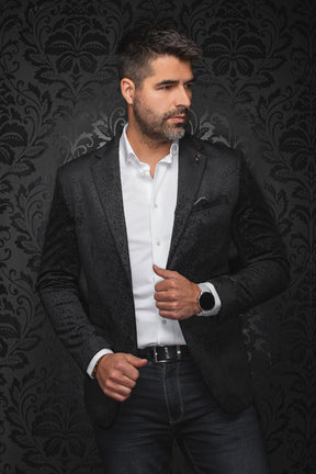 Au Noir men's black paisley jacquard blazer on model, front view with notched lapels and welt pockets