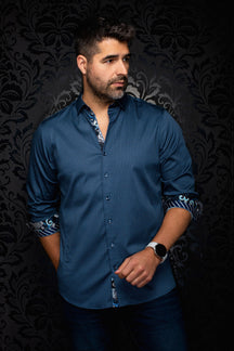 Front model view of men's blue patterned button-up shirt with contrast rolled cuffs and inner placket by Au Noir
