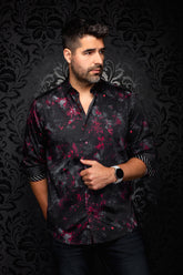 Men's black button-up shirt with red and gray floral print, front model view with rolled sleeves by Au Noir