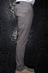 Au Noir men's brown plaid pants shown from the side, with buttoned back pocket and black waistband label
