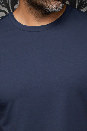 Au Noir men's detail of navy Short-sleeve T-Shirt showing ribbed crewneck and solid jersey fabric