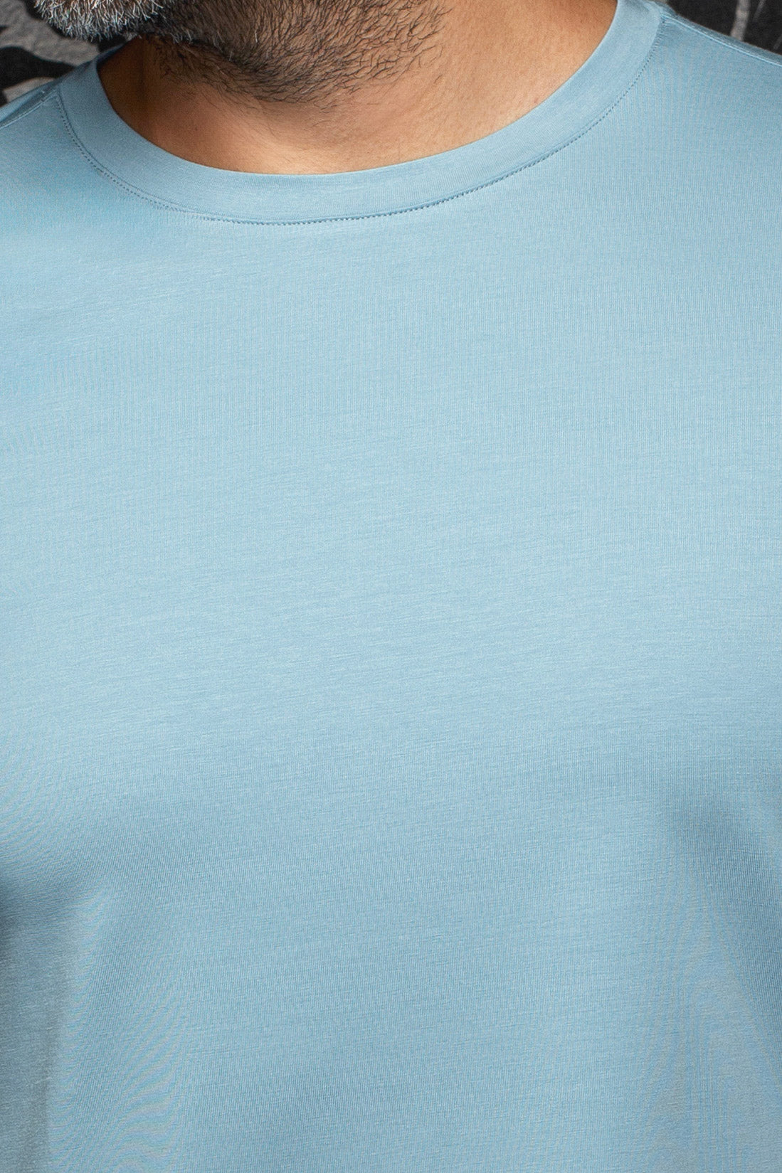 Au Noir men's light blue Short-sleeve T-Shirt showing ribbed crewneck and smooth jersey texture, close-up