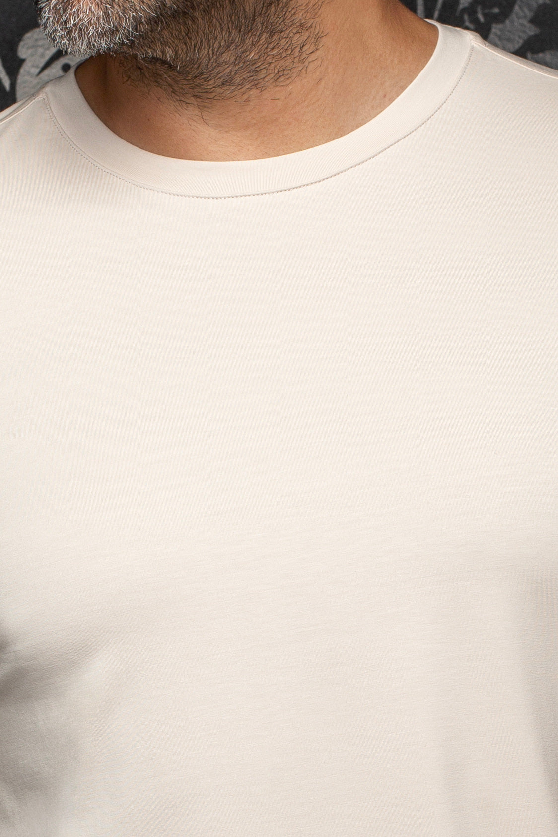 Au Noir men's cream crewneck Short-sleeve T-Shirt collar showing smooth knit fabric and tonal stitching, close-up
