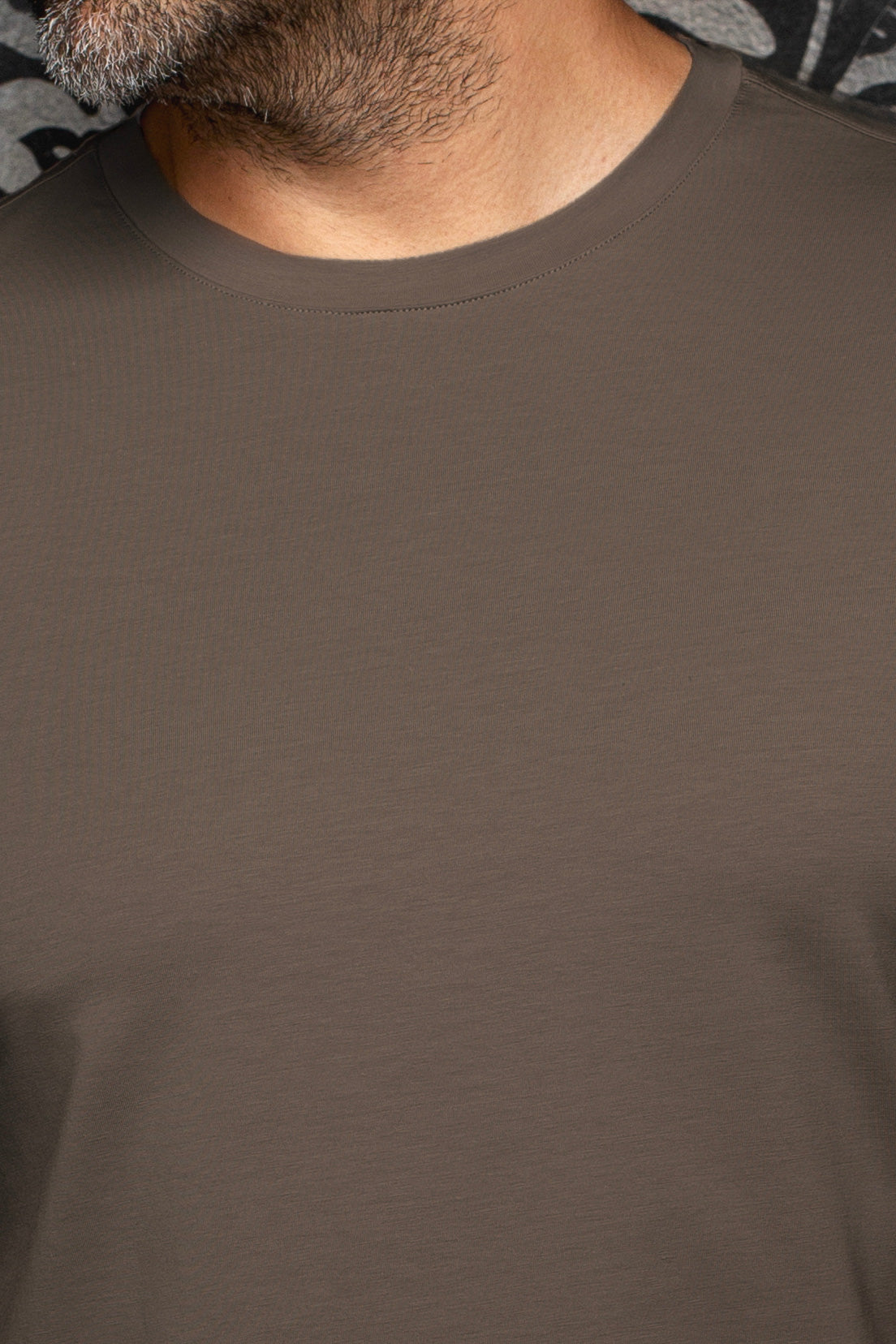 Au Noir men's brown Short-sleeve T-Shirt showing ribbed crewneck collar and smooth jersey texture, close-up