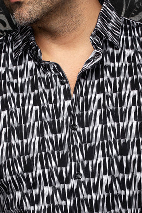 Au Noir men's black and white abstract print shirt showing spread collar, placket, and black buttons, close-up