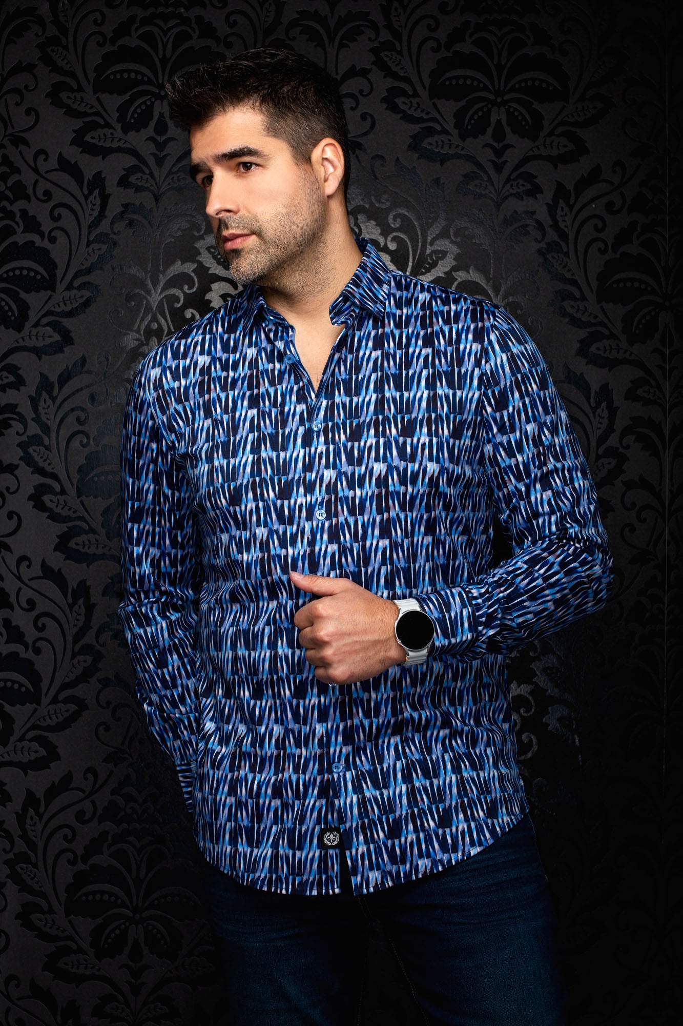 Au Noir men's angled front view of a blue abstract print button-up shirt with long sleeves and curved hem