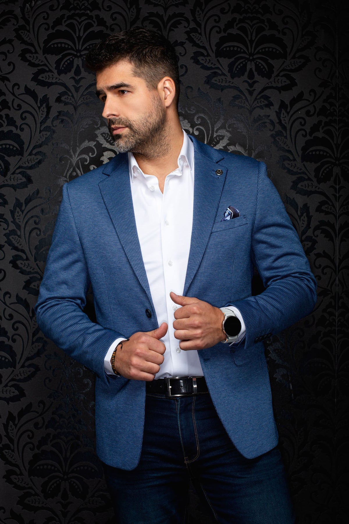 Au Noir men's angled front view of a blue textured blazer with notch lapels, lapel pin and pocket square