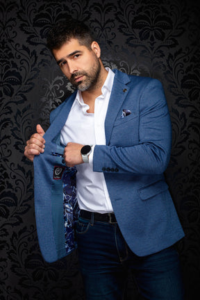 Men's blue textured blazer opened to show patterned blue lining, inner label and dark cuff buttons, detail view by Au Noir