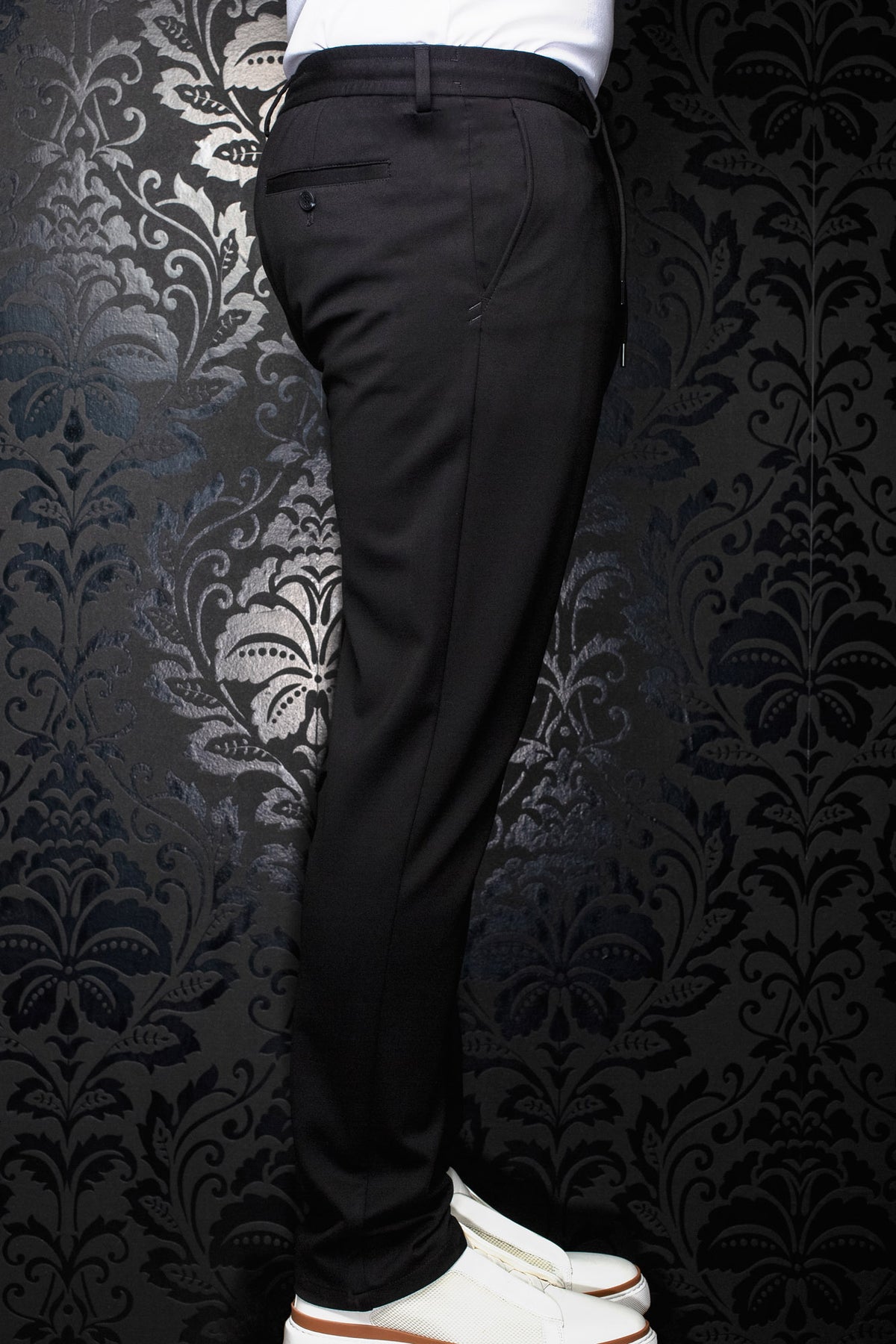 Au Noir men's black pants side view with belt loops, buttoned welt back pocket and tapered leg