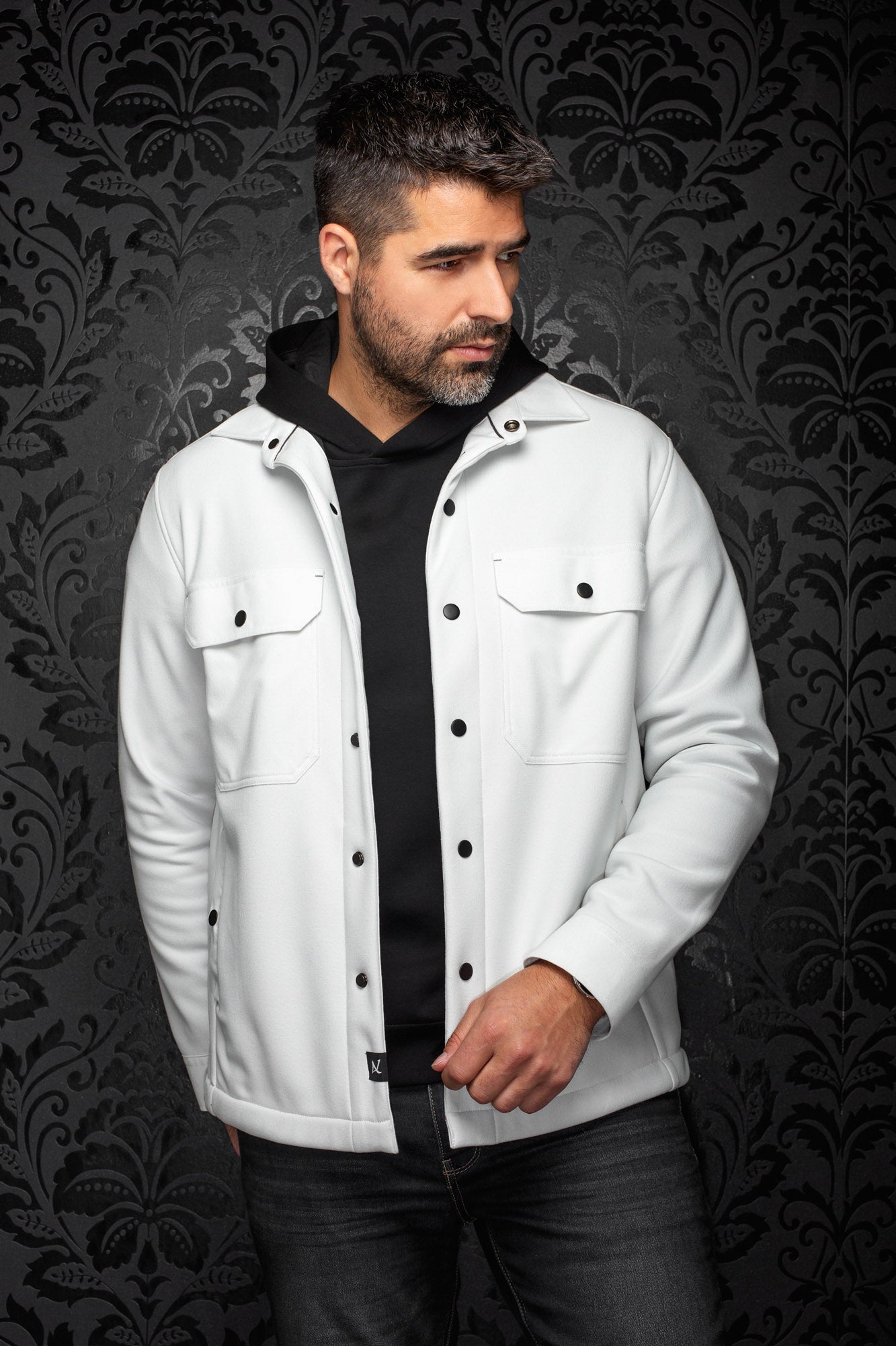 Men's white overshirt front view with black snap buttons and flap chest pockets by Au Noir
