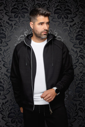 Au Noir men's black hooded zip sport jacket worn open, with silver zipper and long drawstrings, front model view
