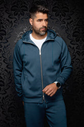 Men's teal full-zip hooded sport jacket on model, front view with drawstrings and split pockets by Au Noir
