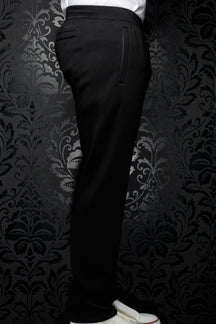 Side view of men's black jogging pants with elastic waistband, drawstring and vertical pocket detail by Au Noir