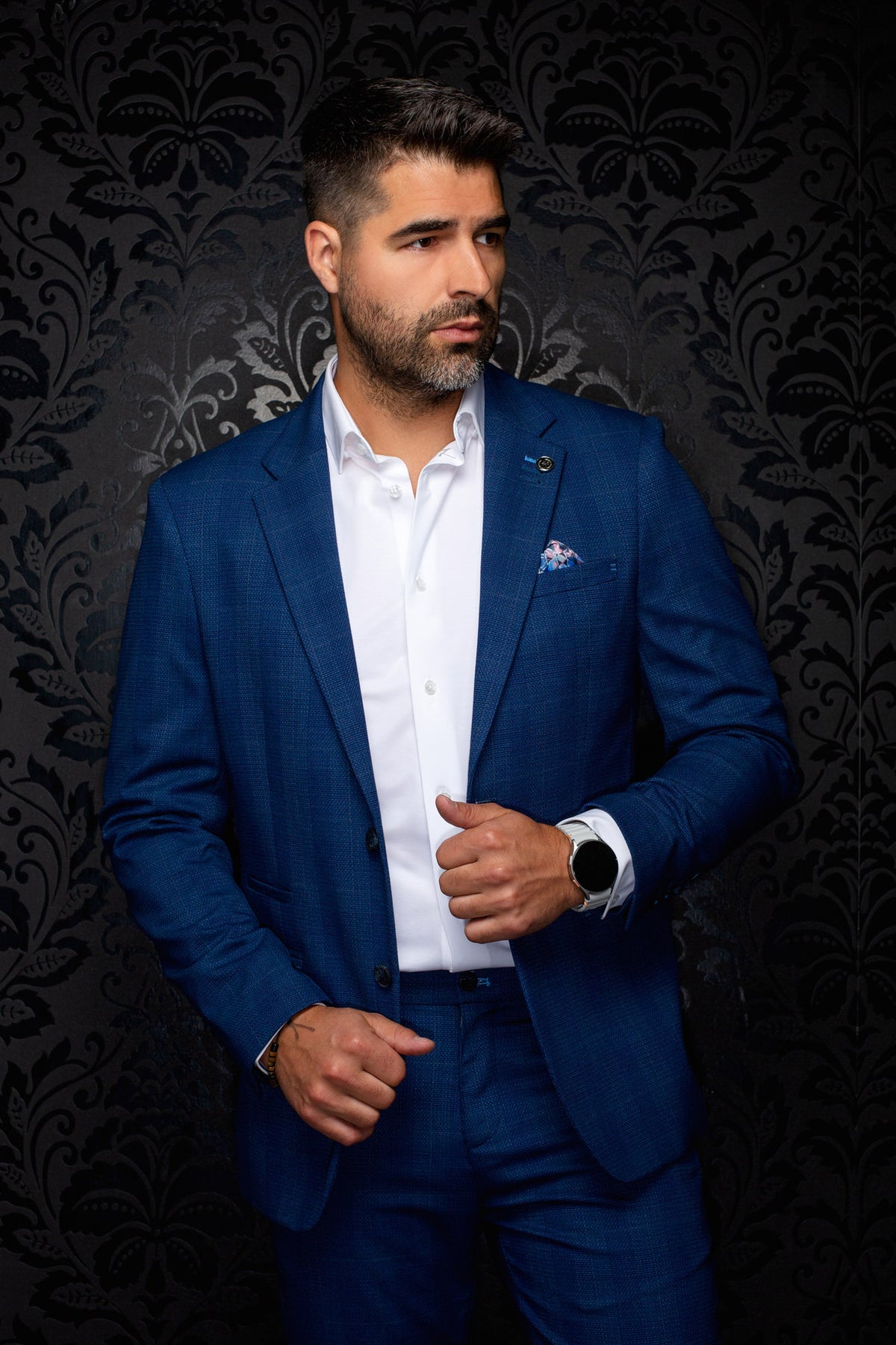 Au Noir men's blue textured blazer with notch lapels, flap pockets, and lapel pin shown from the front