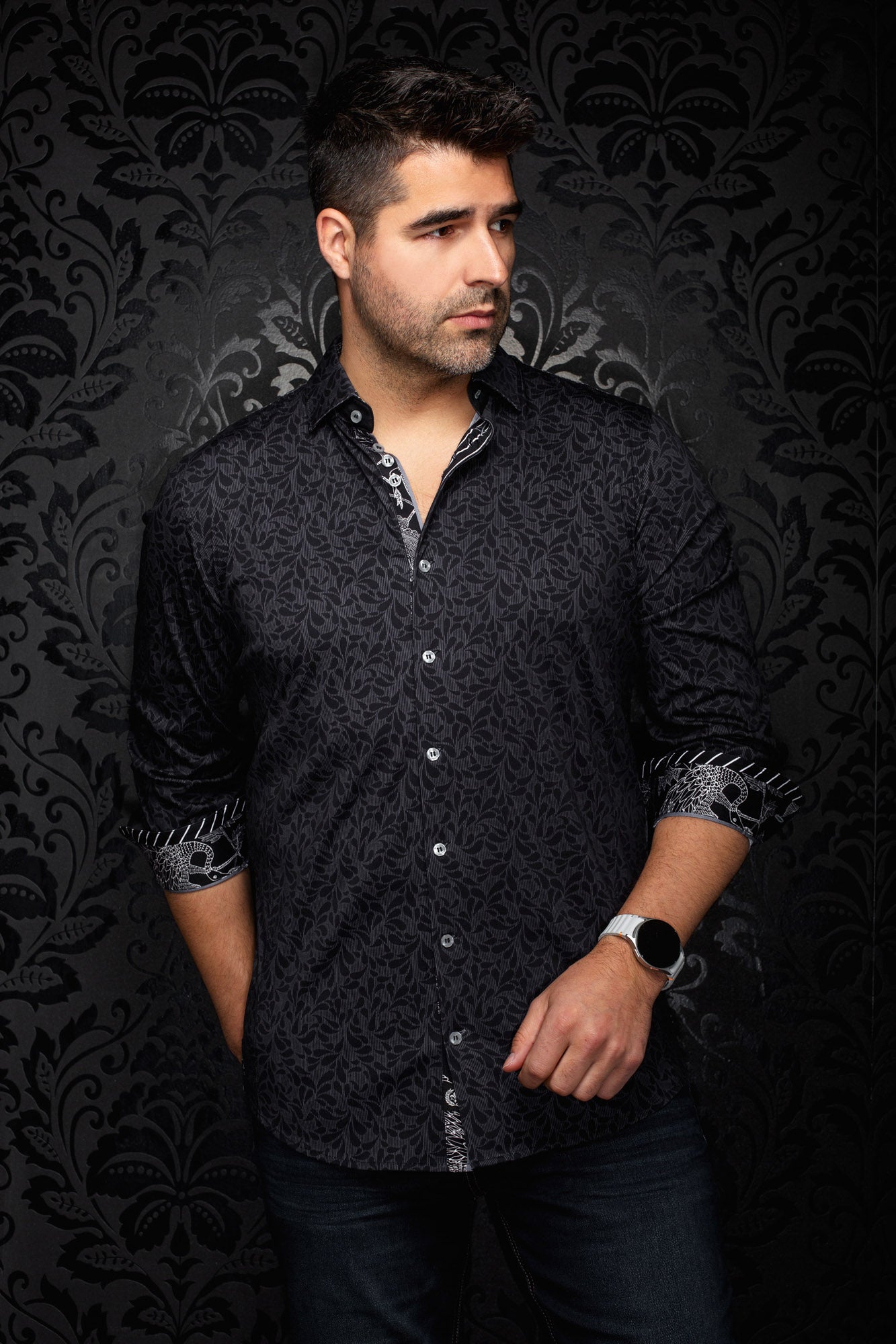 Men's black tonal floral button-up shirt, front model view with rolled contrast cuffs and light buttons by Au Noir