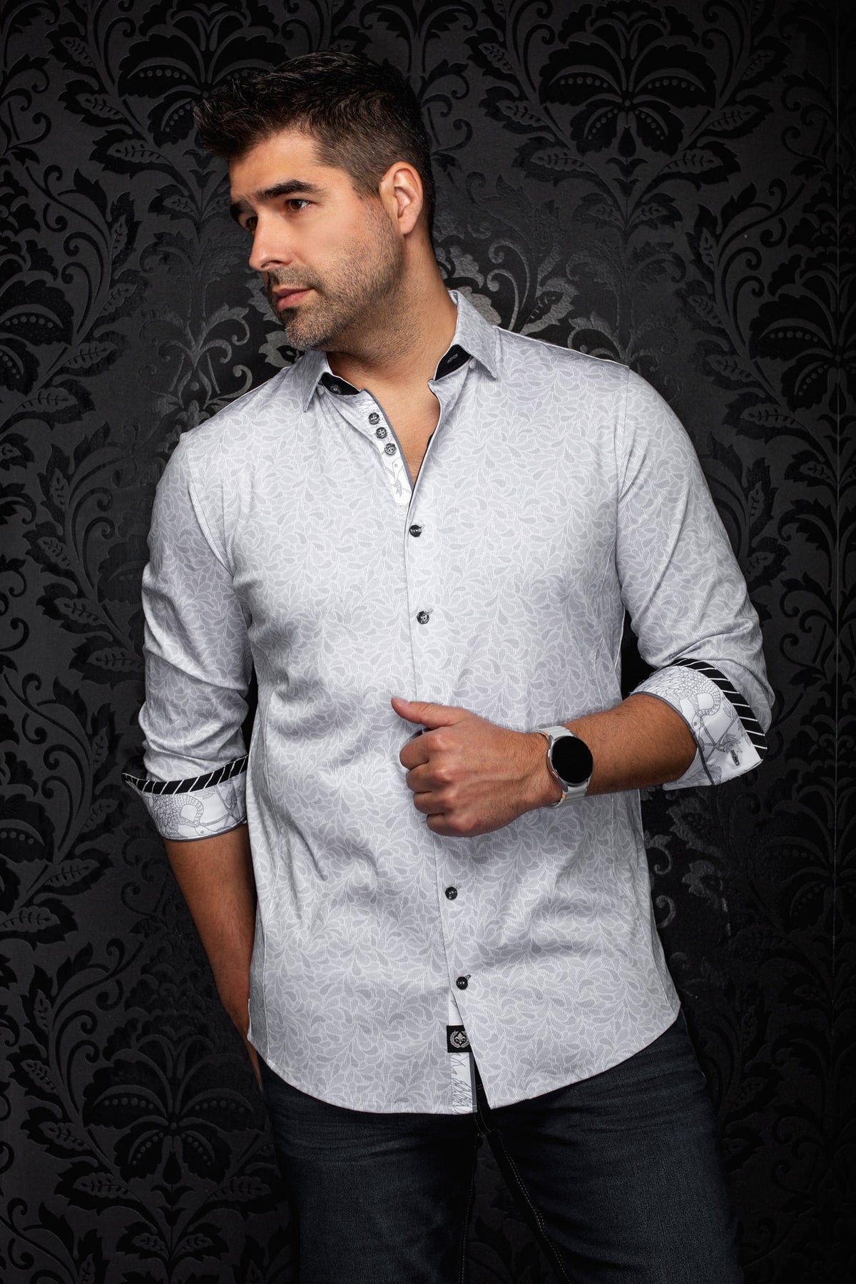 Au Noir men's angled model view of a light gray floral shirt with rolled cuffs and black contrast trim, side view