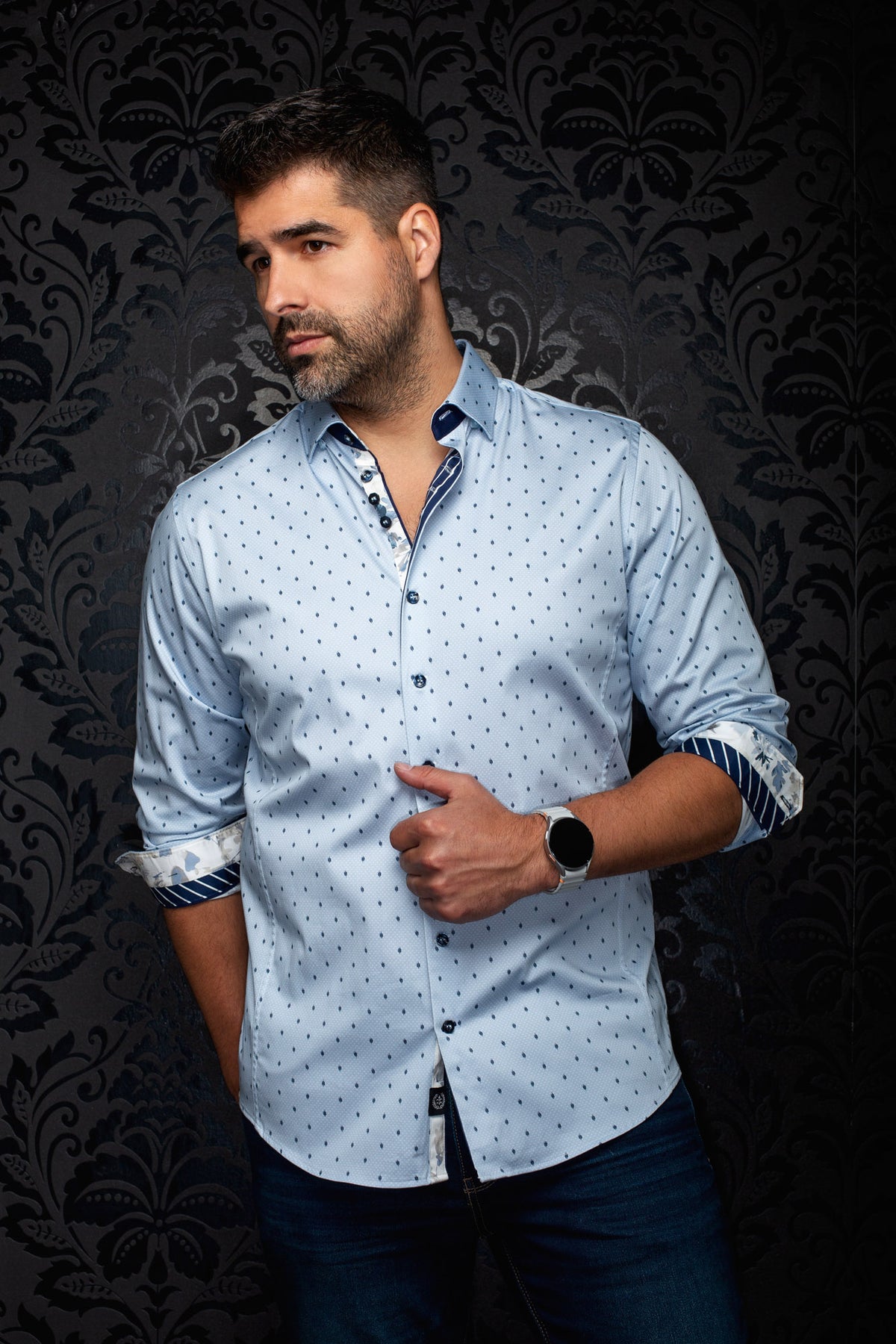 Men's light blue button-up shirt on model with small navy leaf print and rolled contrast cuffs, front view by Au Noir