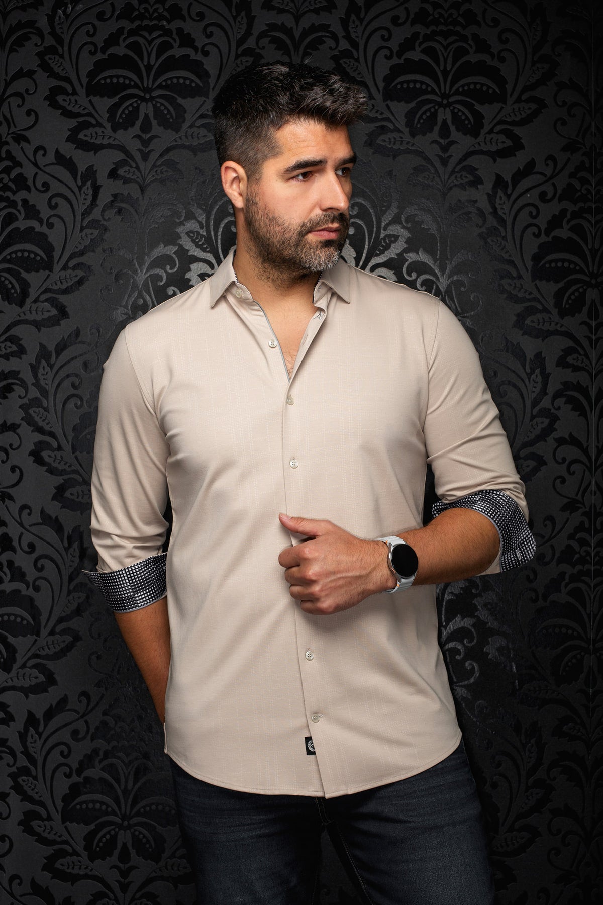 Au Noir men's beige button-up shirt front view with sleeves rolled to show black-and-white patterned cuffs