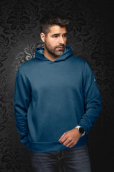Men's teal blue pullover sport jacket on model, front view with attached hood and ribbed hem by Au Noir