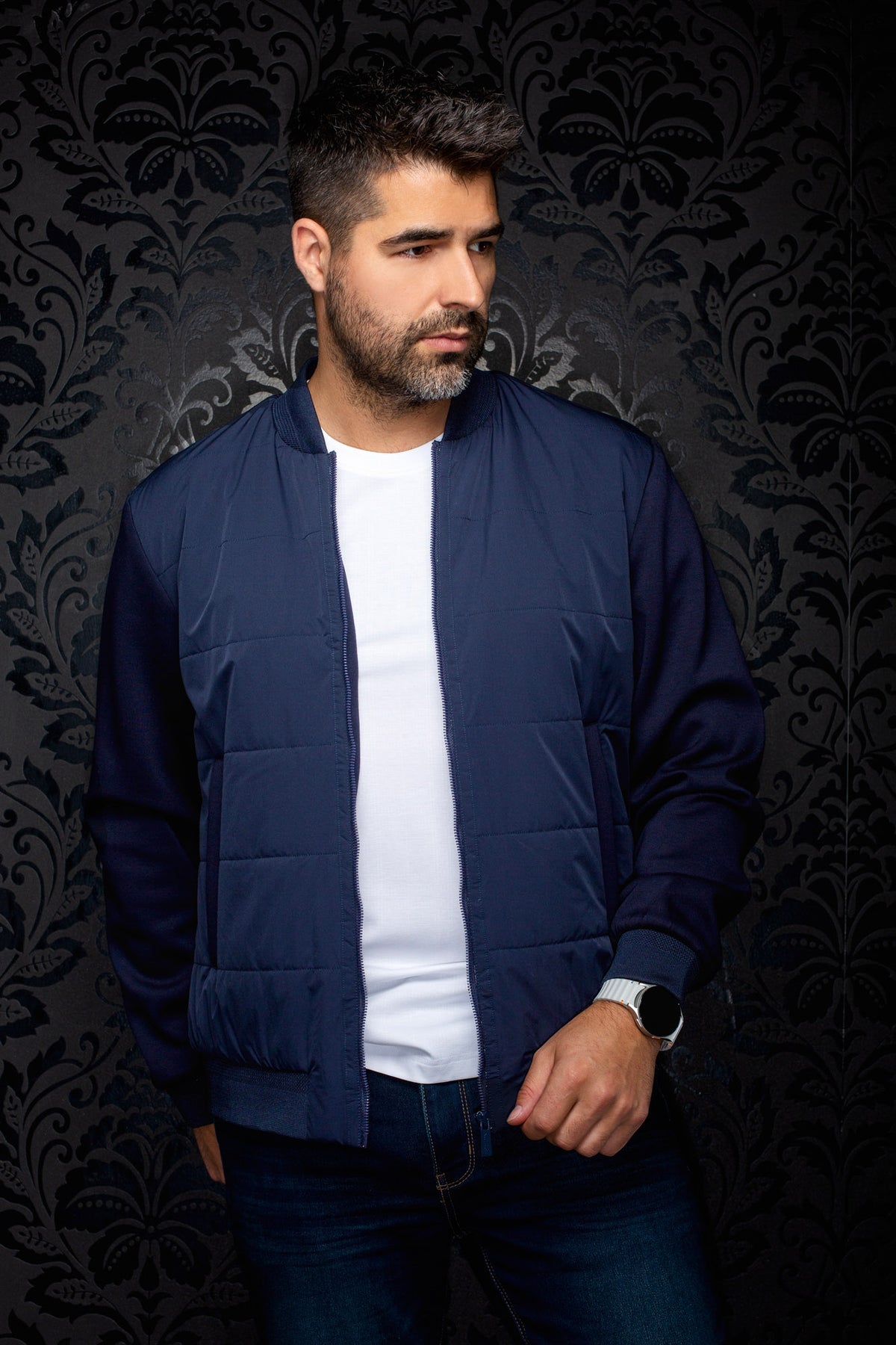 Au Noir men's navy bomber jacket on model, open front zipper, ribbed cuffs and subtle tonal chest logo