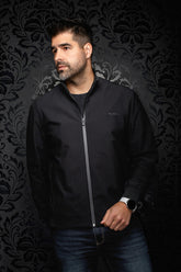 Au Noir men's black bomber jacket zipped up, with ribbed collar, cuffs and gray zipper trim shown from the front