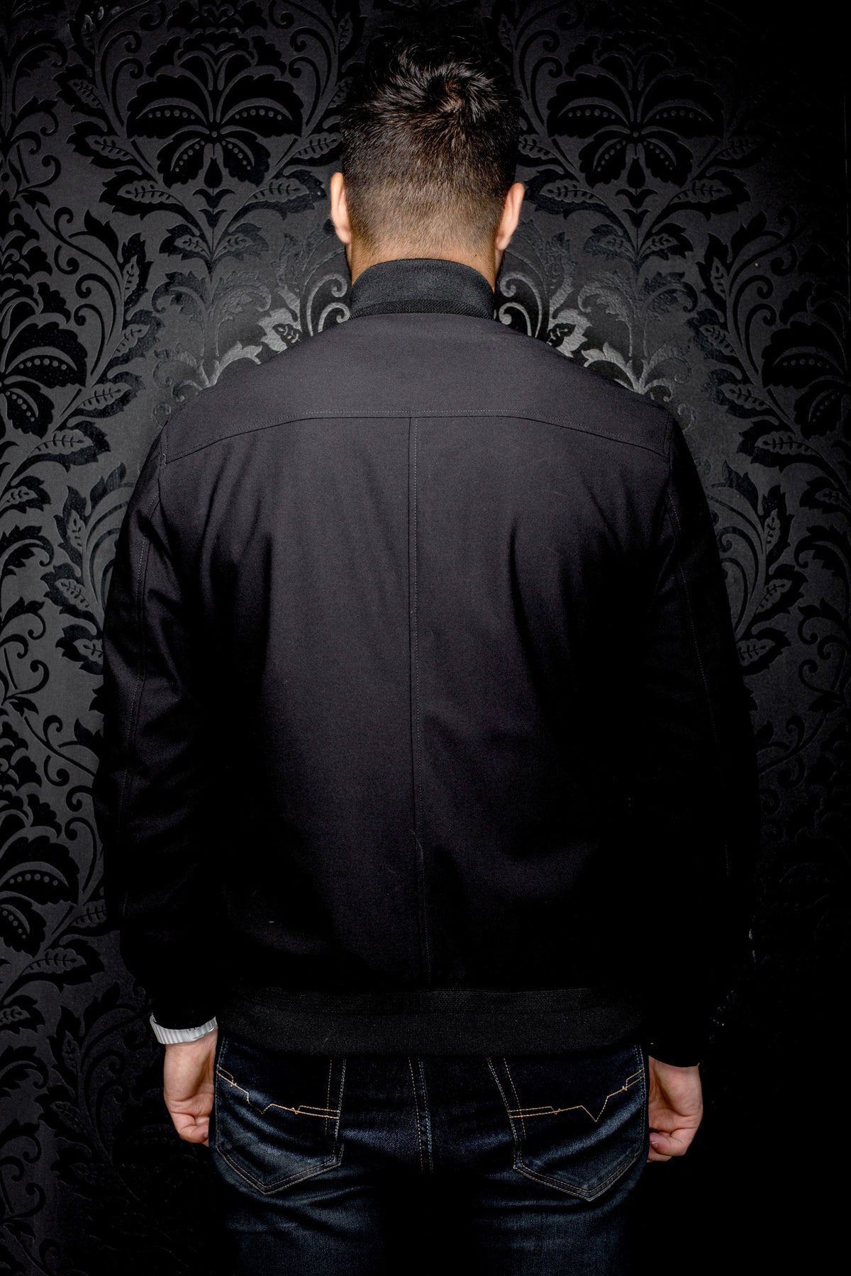 Au Noir men's black bomber jacket with ribbed collar, waistband, back yoke and center seam, back view
