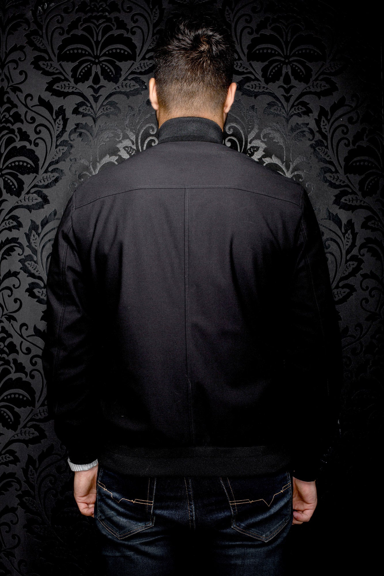Au Noir men's black bomber jacket with ribbed collar, waistband, back yoke and center seam, back view