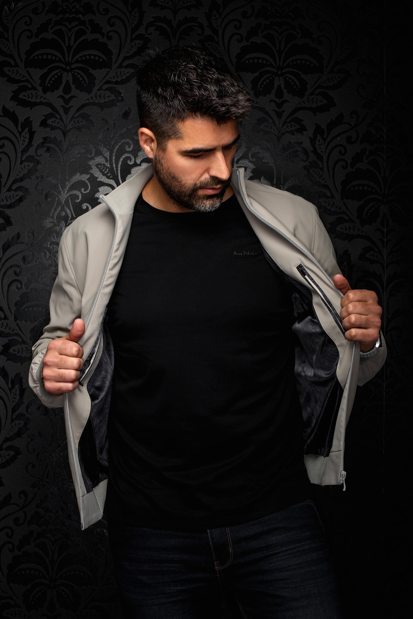 Au Noir men's open light gray bomber jacket showing black shiny lining, inside zip pocket, and ribbed collar, detail view