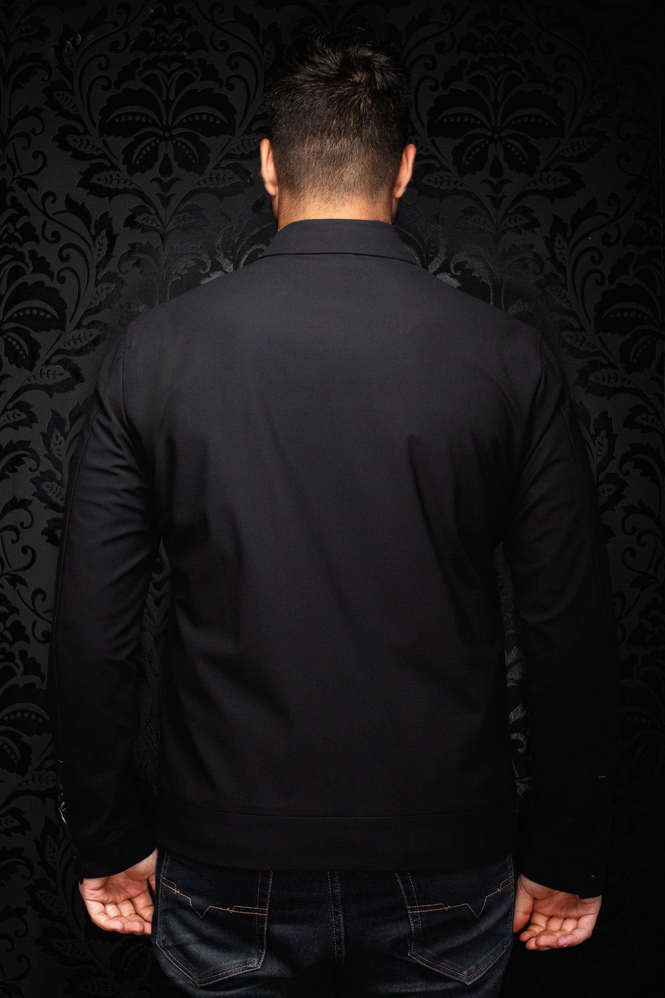 Au Noir men's solid black bomber jacket with pointed collar, long sleeves, and straight hem shown from the back