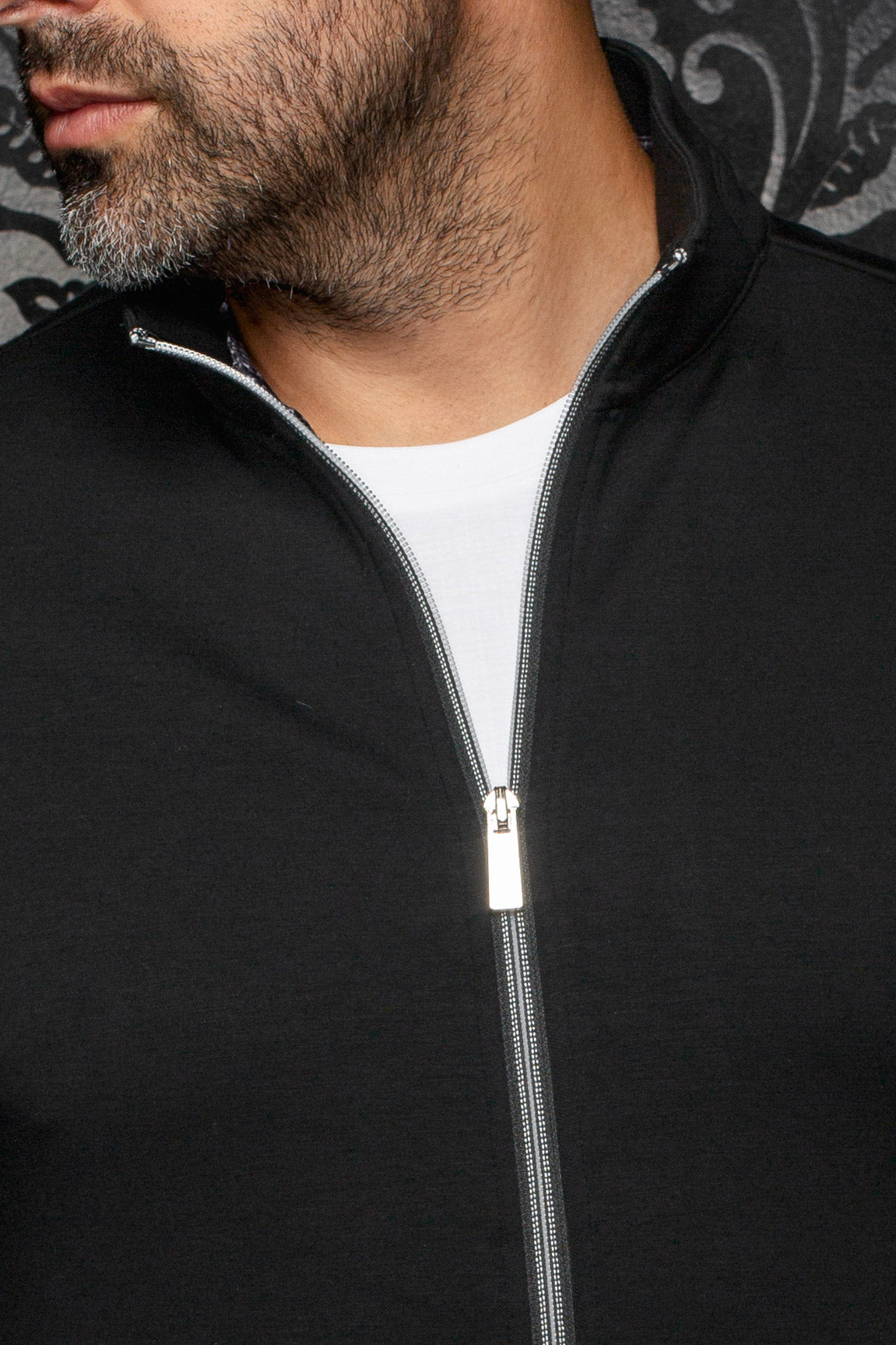 Au Noir men's black sport jacket stand collar and silver front zipper partially open over a white T-Shirt, close-up