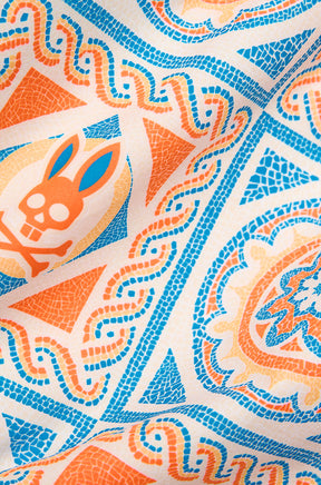 Psycho Bunny men's cream fabric with orange and blue mosaic tile print and bunny skull motif, close-up