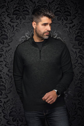 Men's black textured knit quarter-zip cashmere sweater shown from the front on a model by Au Noir