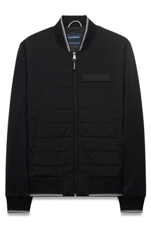 Men's black zip-front windbreaker jacket with hem, cuffs, striped rib collar and quilted front, product view by Psycho Bunny