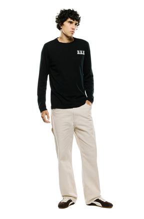 Men's full-body angled front view of black long sleeve T-Shirt with white chest graphic by Psycho Bunny
