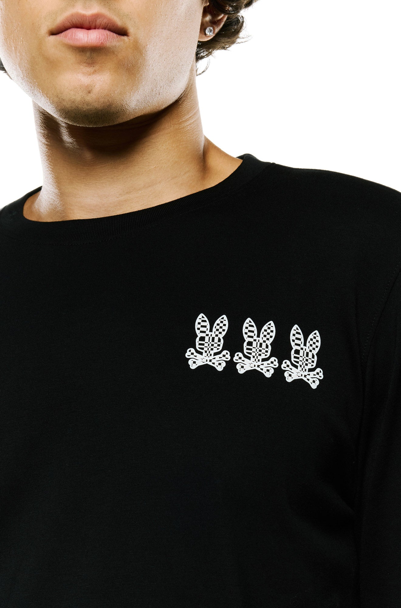 Men's front chest detail of black long sleeve T-Shirt with three white bunny logos and ribbed crewneck by Psycho Bunny
