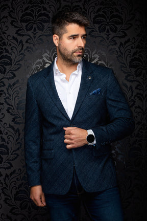 Au Noir men's angled front view of a navy textured blazer with notched lapels, flap pockets, and lapel pin