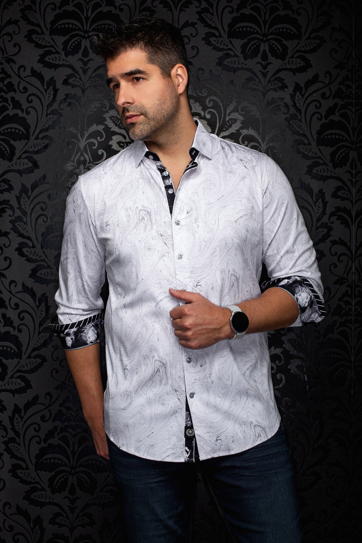 Au Noir men's angled model view of white marbled shirt with rolled cuffs revealing black contrast print, side view