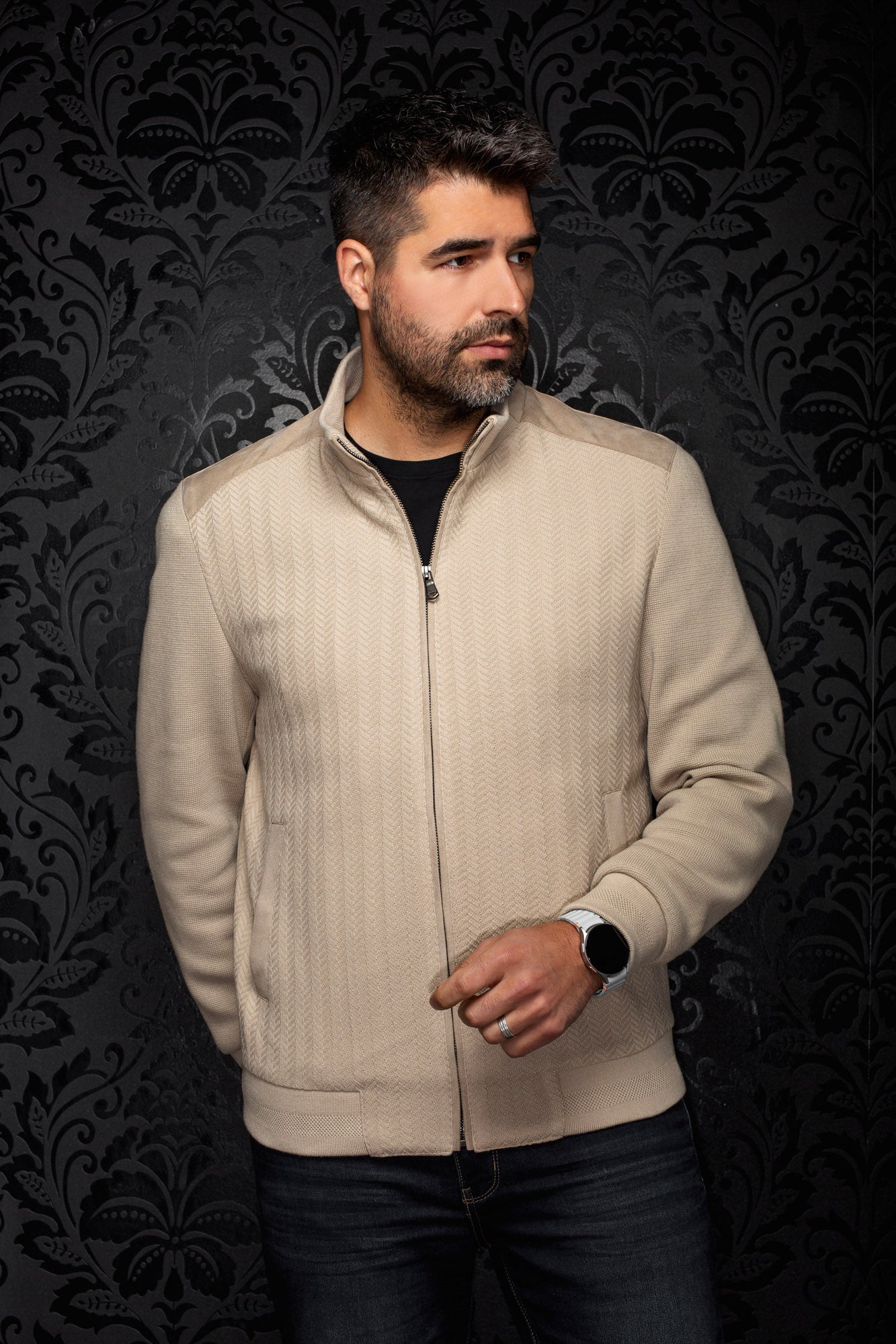 Men's beige zip bomber jacket on model, front view with stand collar, ribbed hem and herringbone texture by Au Noir