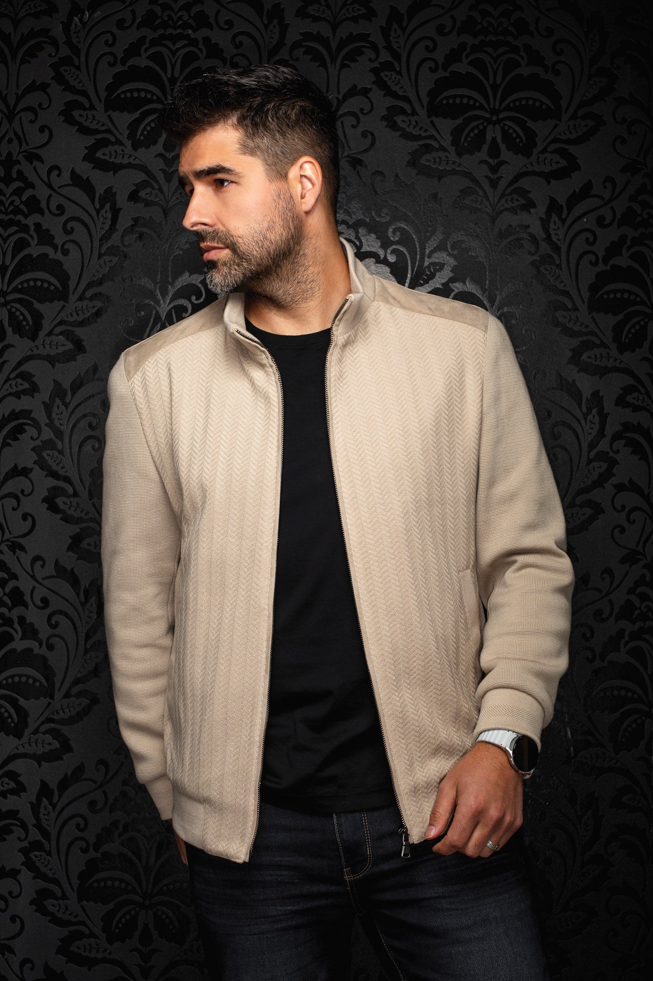 Au Noir men's beige zip bomber jacket on model, angled front view with stand collar and textured front panels
